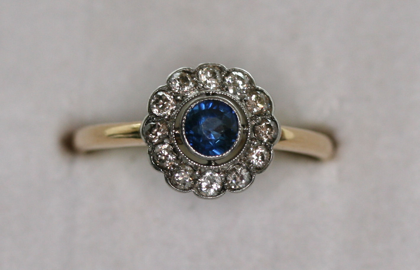 A sapphire and diamond floral cluster ring