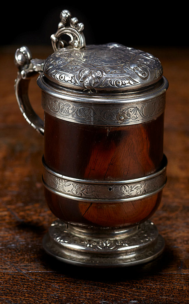A rare mid 17th century silver mounted wooden tankard