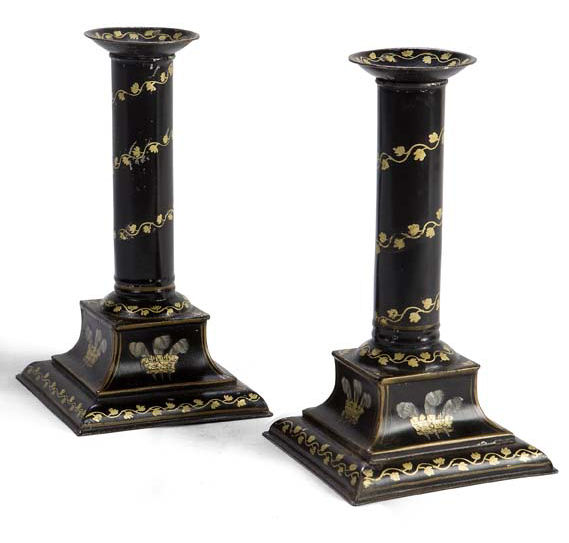 A pair of Regency toleware candlesticks