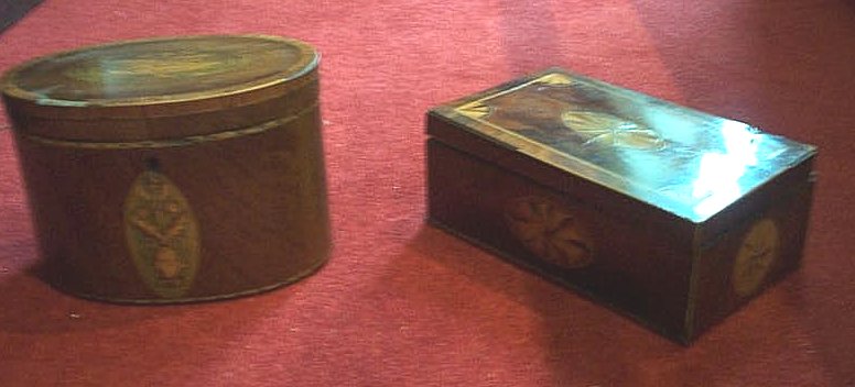 A George III mahogany and inlaid oval tea caddy,