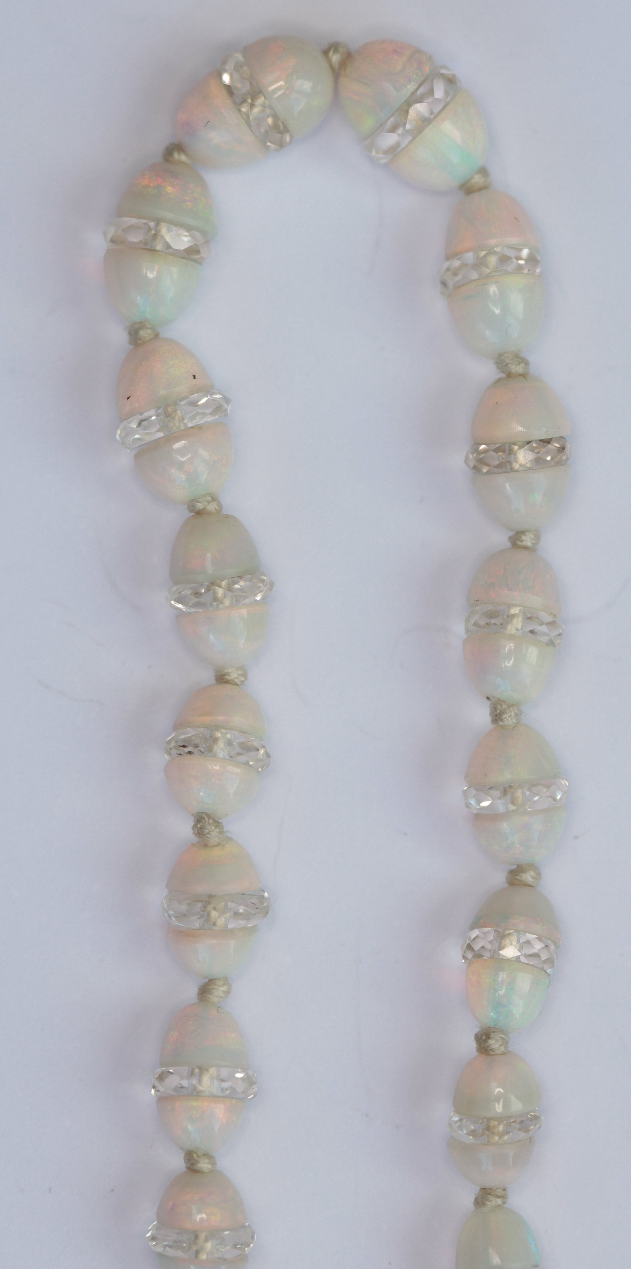 A Belle Epoque opal and rock crystal bead necklace with diamond set clasp