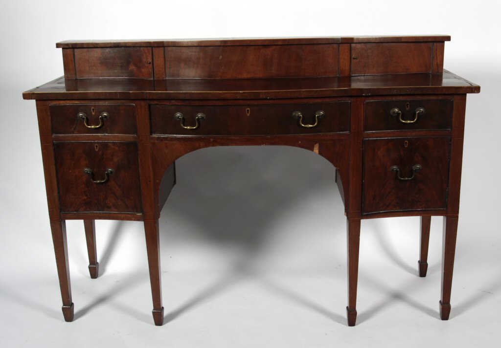 A Georgian style mahogany serpentine sideboard