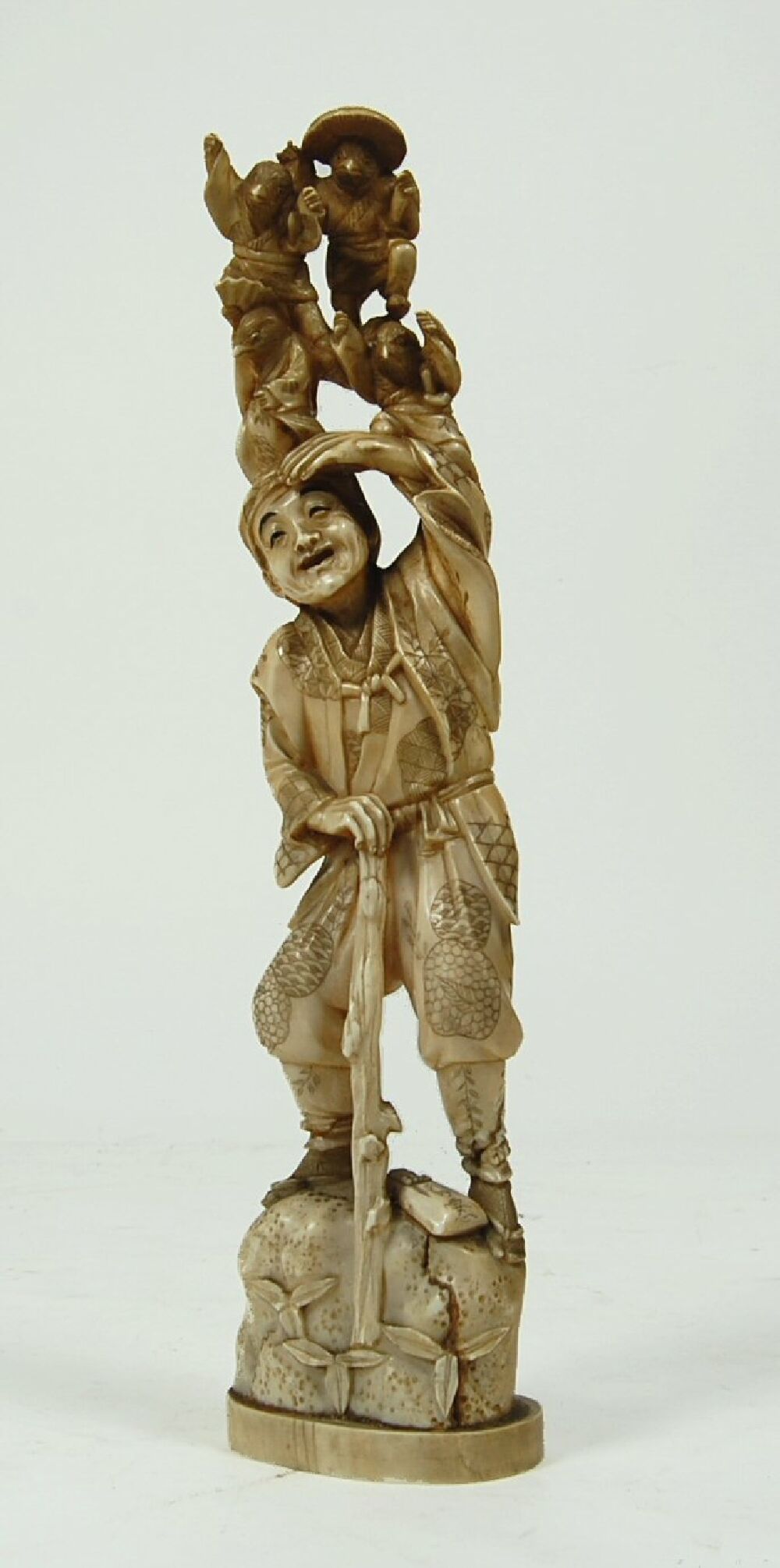 A tall Japanese carved ivory tusk figure, Meiji period