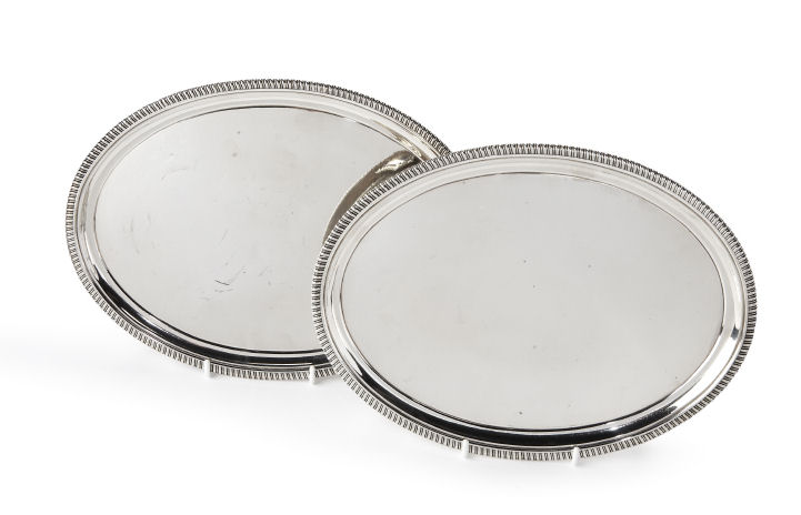 A pair of George III oval silver waiters