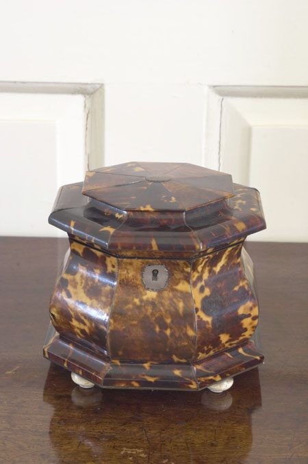 A Regency tortoiseshell and silver inlaid bombe tea caddy