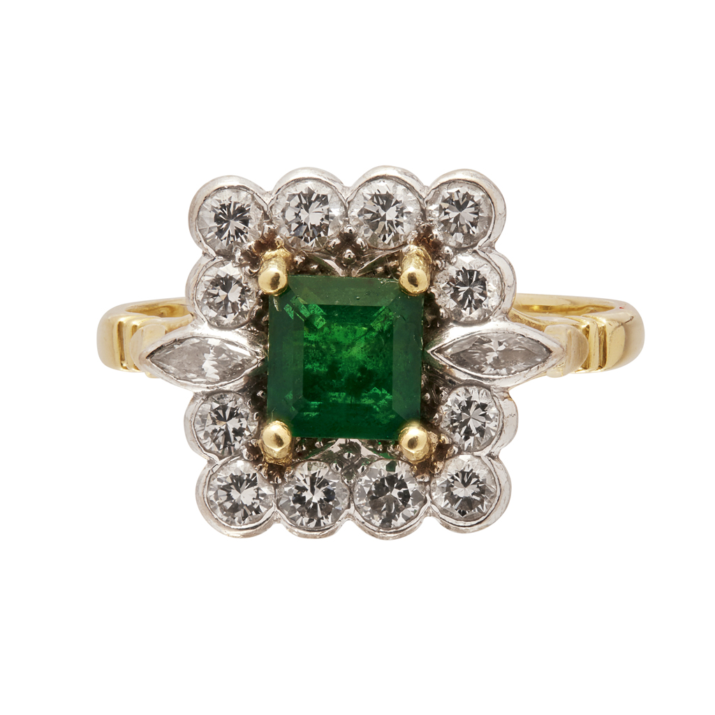 An emerald and diamond set cluster ring