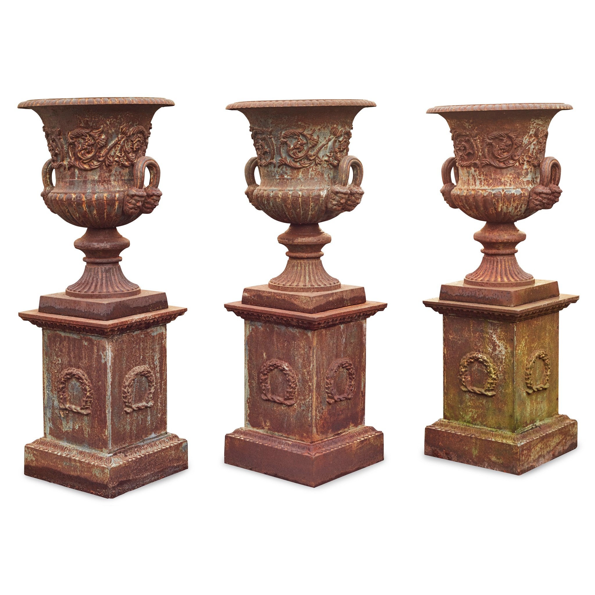GROUP OF THREE CAST IRON GARDEN URNS AND PLINTHS
