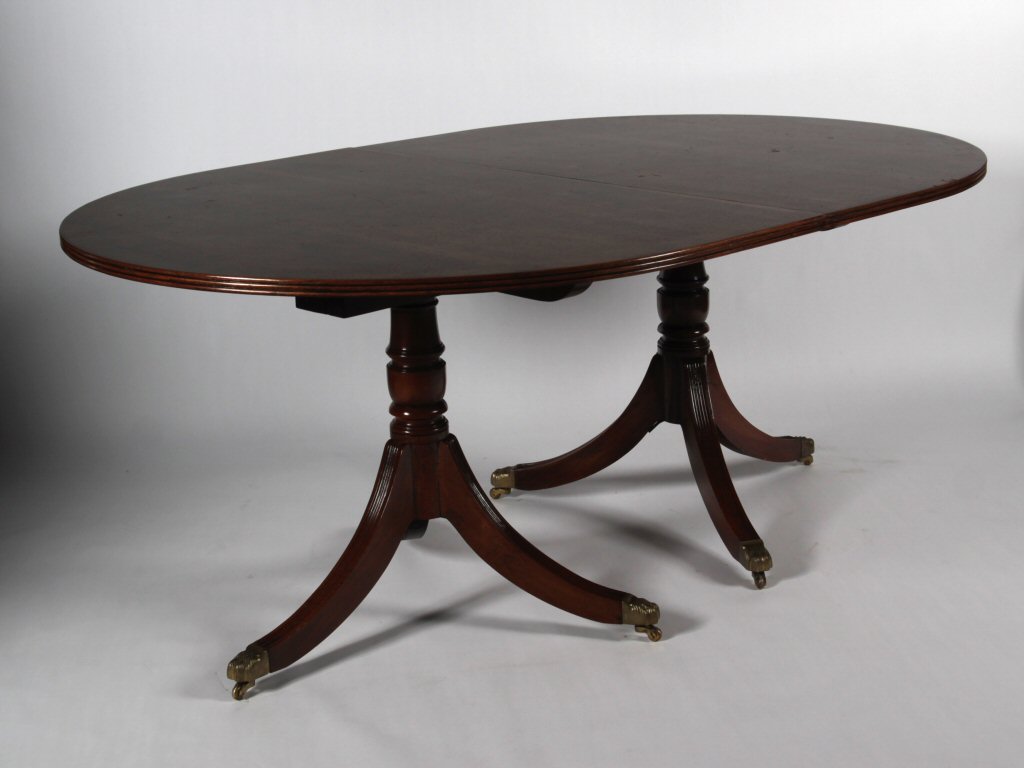 A Regency style mahogany twin pedestal dining table