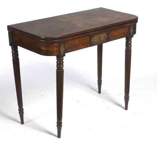 A Regency period rosewood and cut brass inlaid fold over games table