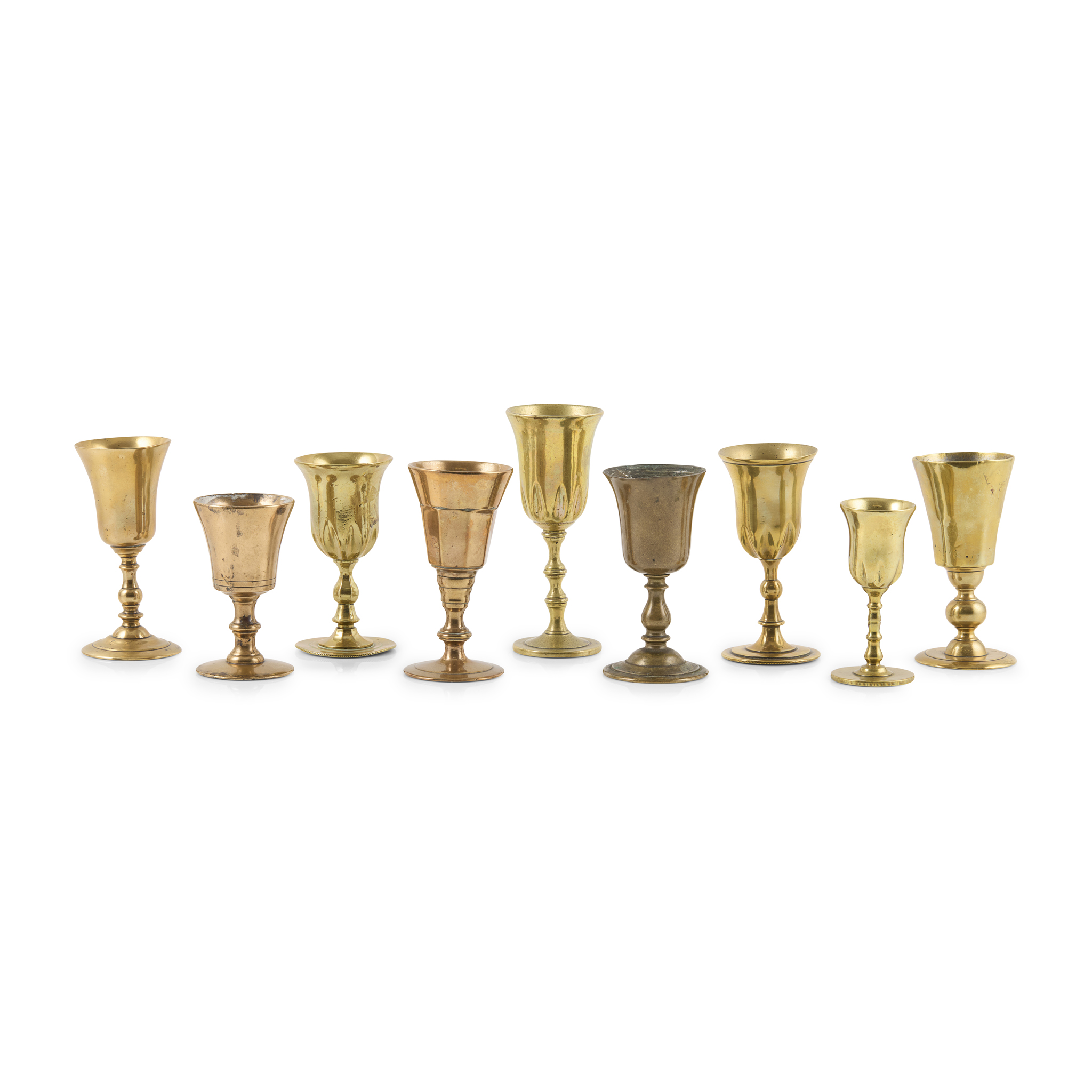 COLLECTION OF NINE GEORGIAN BRASS TRAVELLING WINE OR COMMUNION GOBLETS