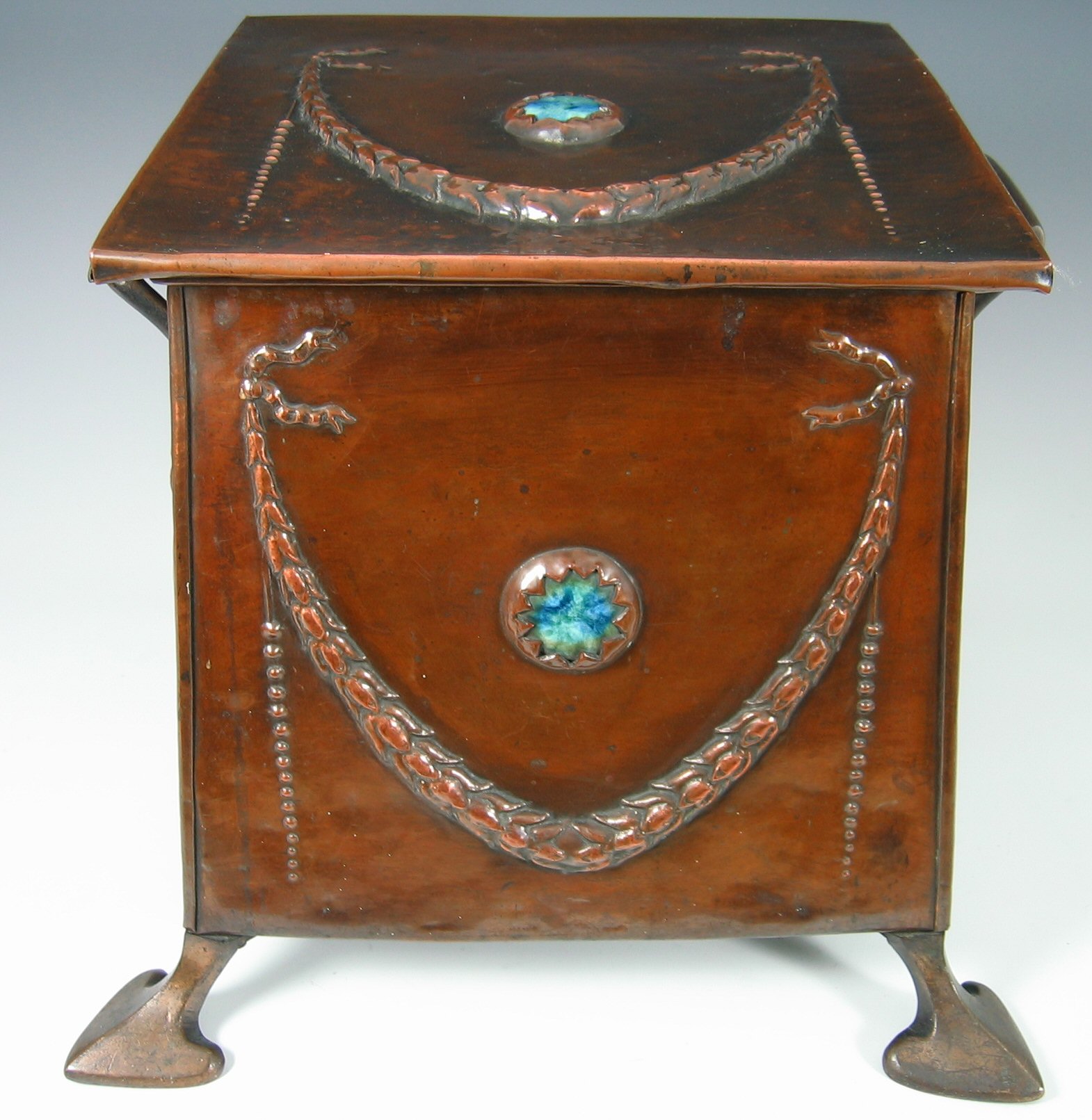 A patinated copper coal bin,