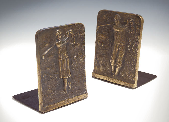 A pair of bronze golfing bookends,