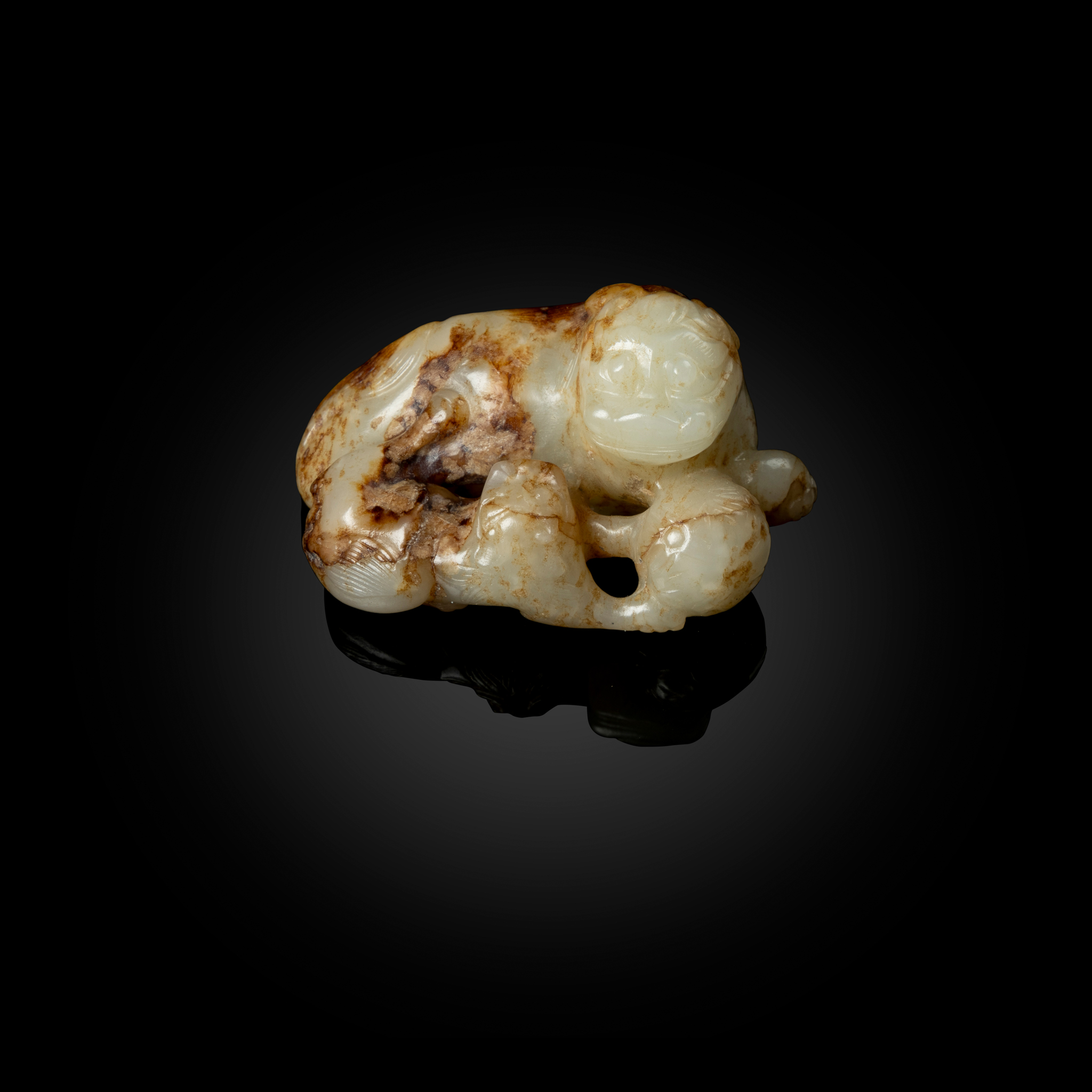 CHINESE WHITE JADE CARVING WITH RUSSET INCLUSIONS OF A MOTHER LION AND CUB