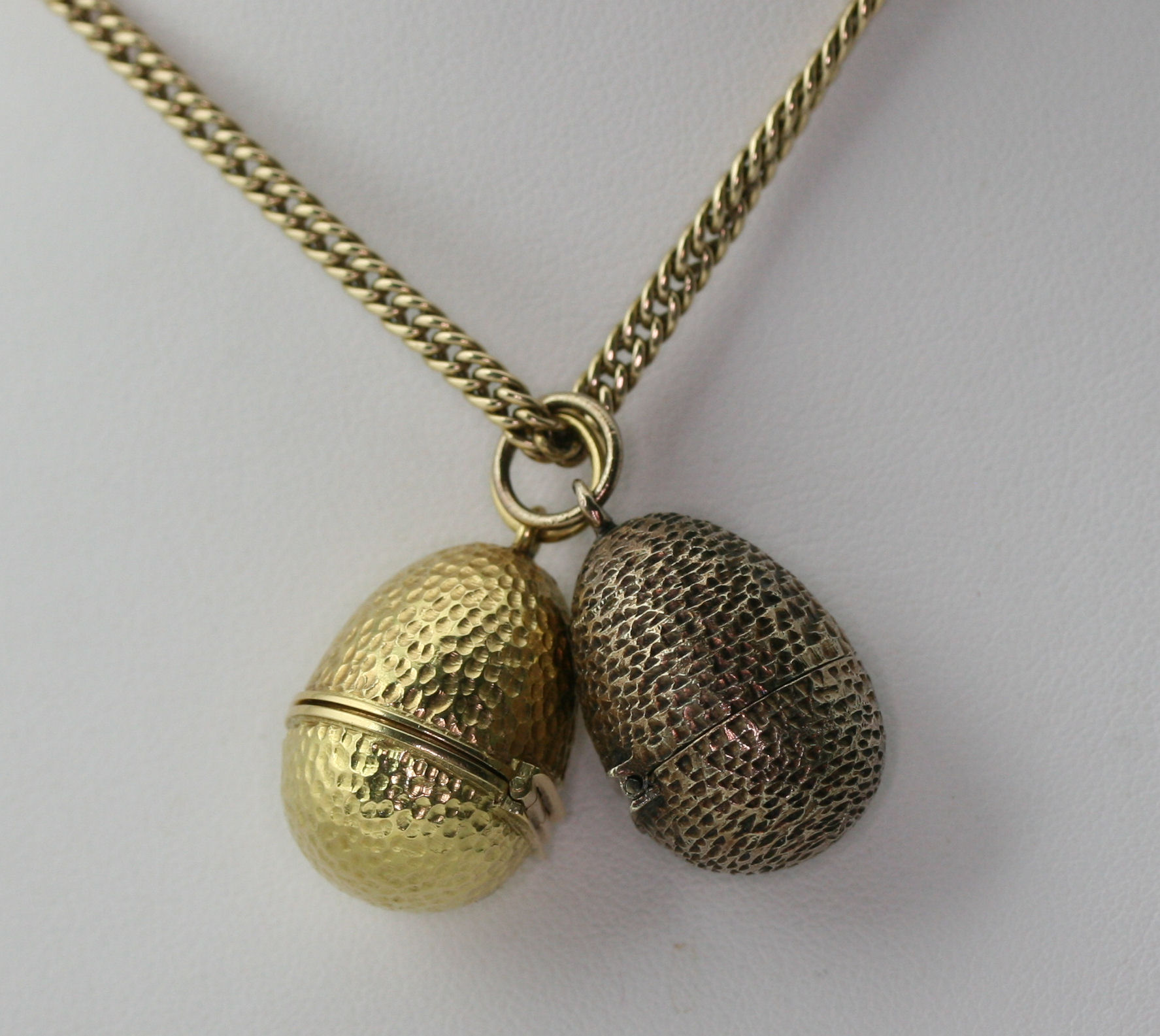 STUART DEVLIN - two 1970's ovoid lockets with chain