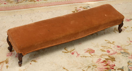 A Victorian upholstered and mahogany fender stool
