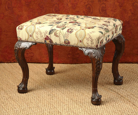 A mahogany and upholstered stool
