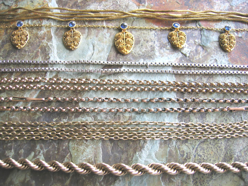 A group of gold neck chains,