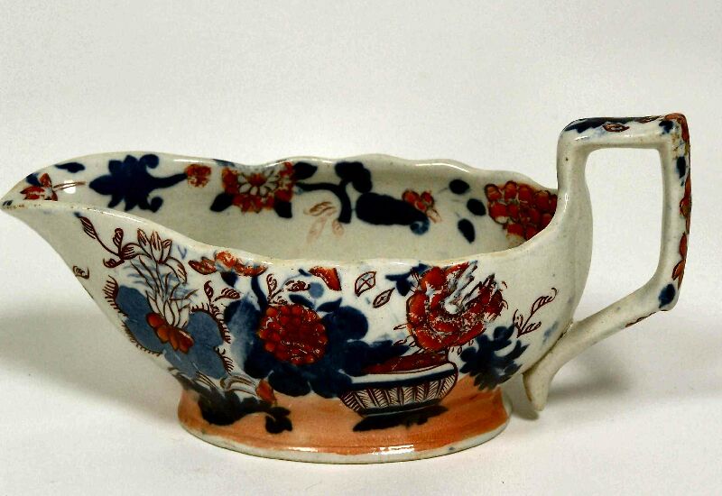An early 19th century ironstone gravy boat