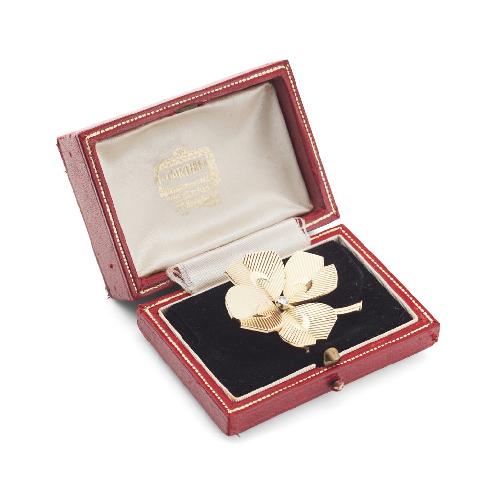 CARTIER - A 1950s 18ct gold mounted diamond set four-leaf clover brooch