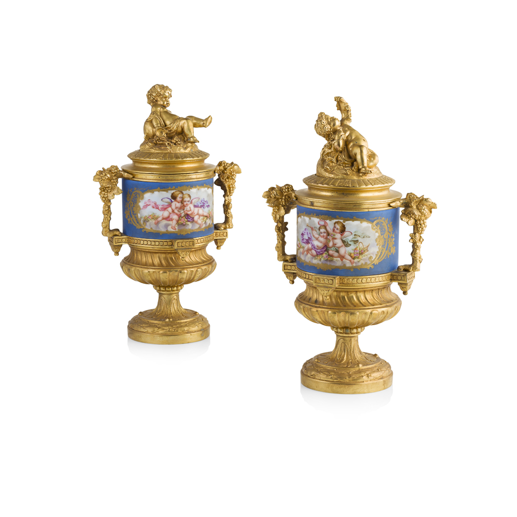 PAIR OF FRENCH PORCELAIN AND GILT BRONZE COVERED URNS