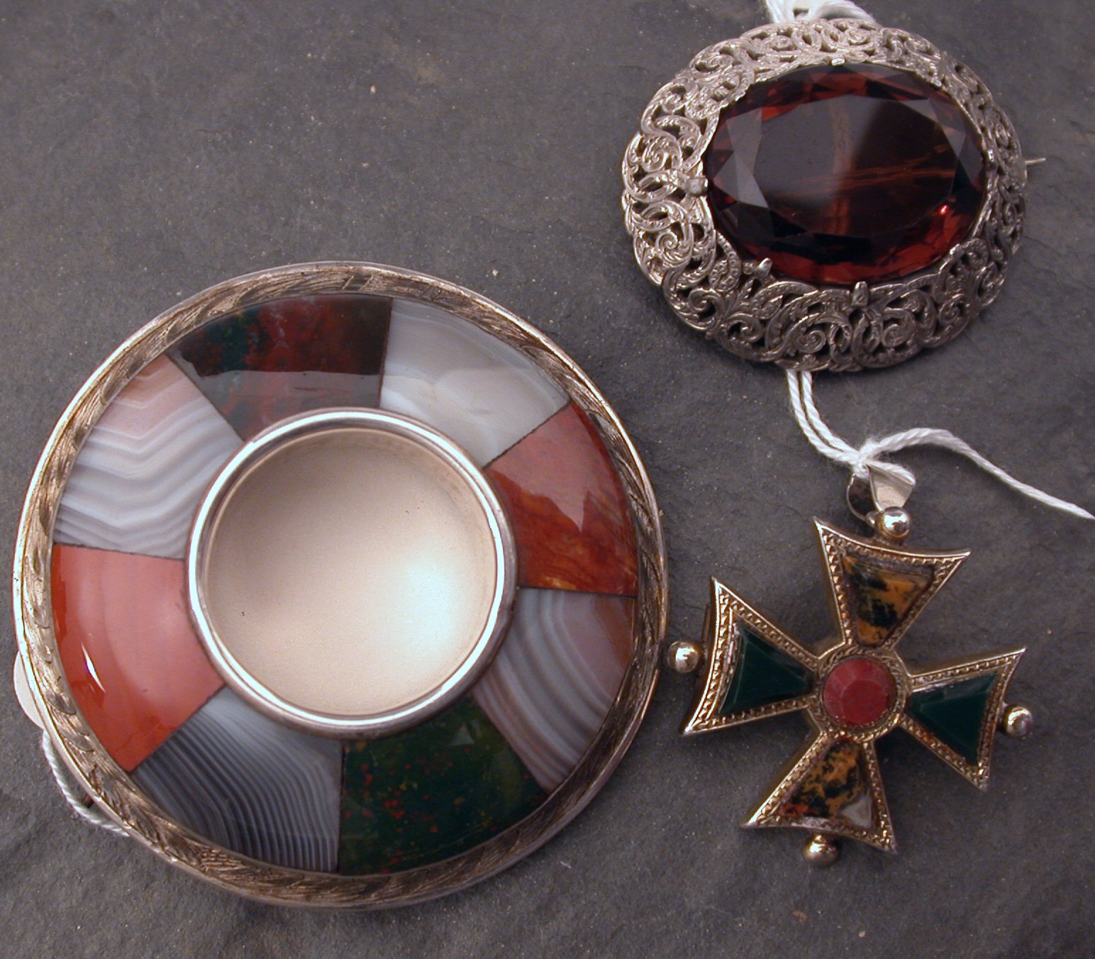 A 19th century open set circular banded multi-agate brooch with decorative engraved silver surround,