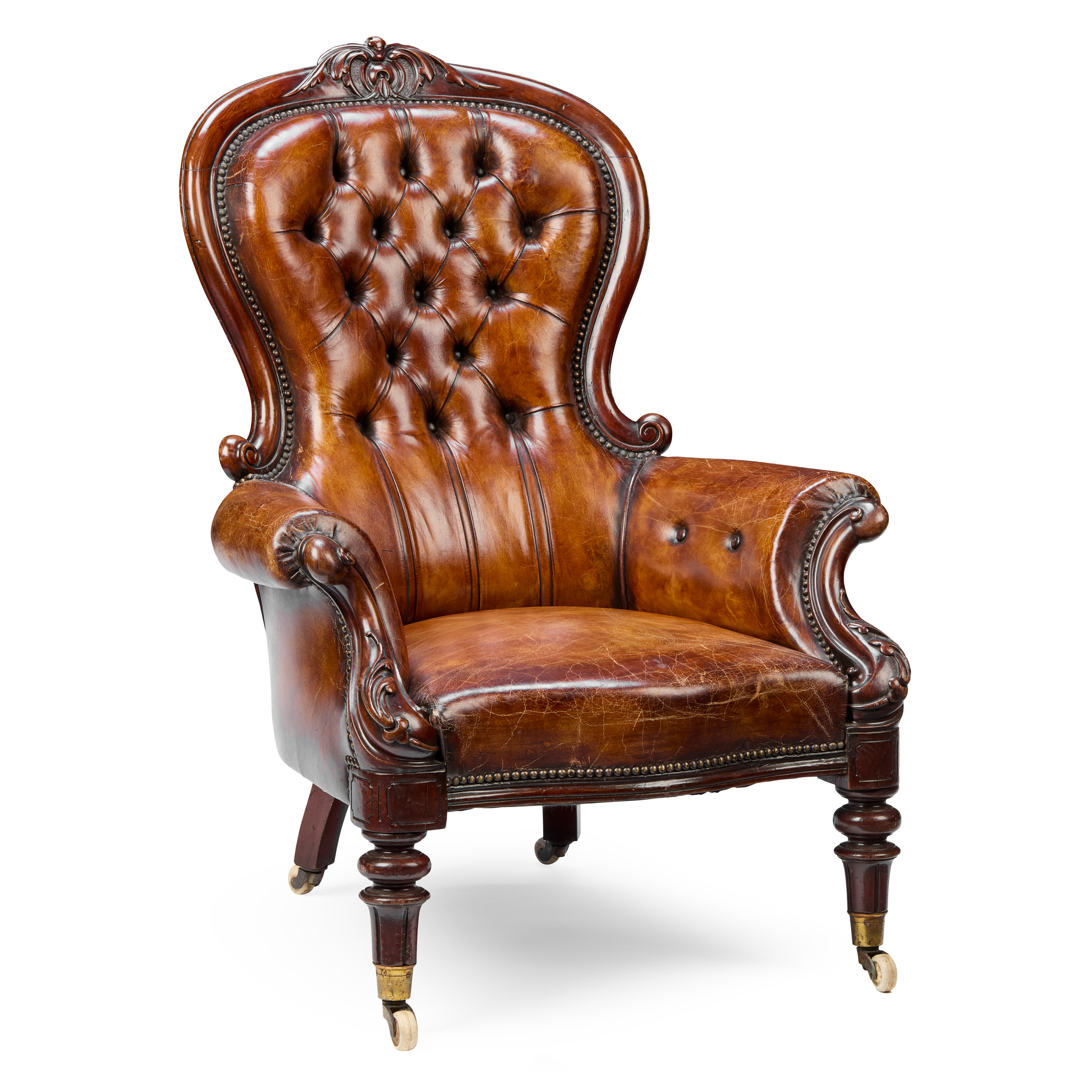A VICTORIAN LEATHER UPHOLSTERED SPOONBACK ARMCHAIR