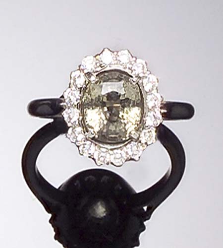 A green sapphire and diamond cluster ring,