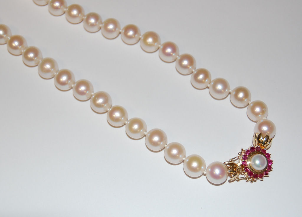 A cultured pearl necklace with ruby set clasp
