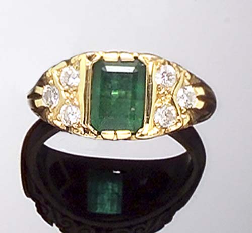 An 18ct gold mounted emerald and diamond ring,