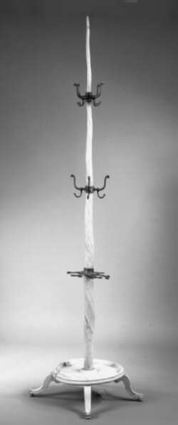 A Narwal tusk mounted as a hat stand