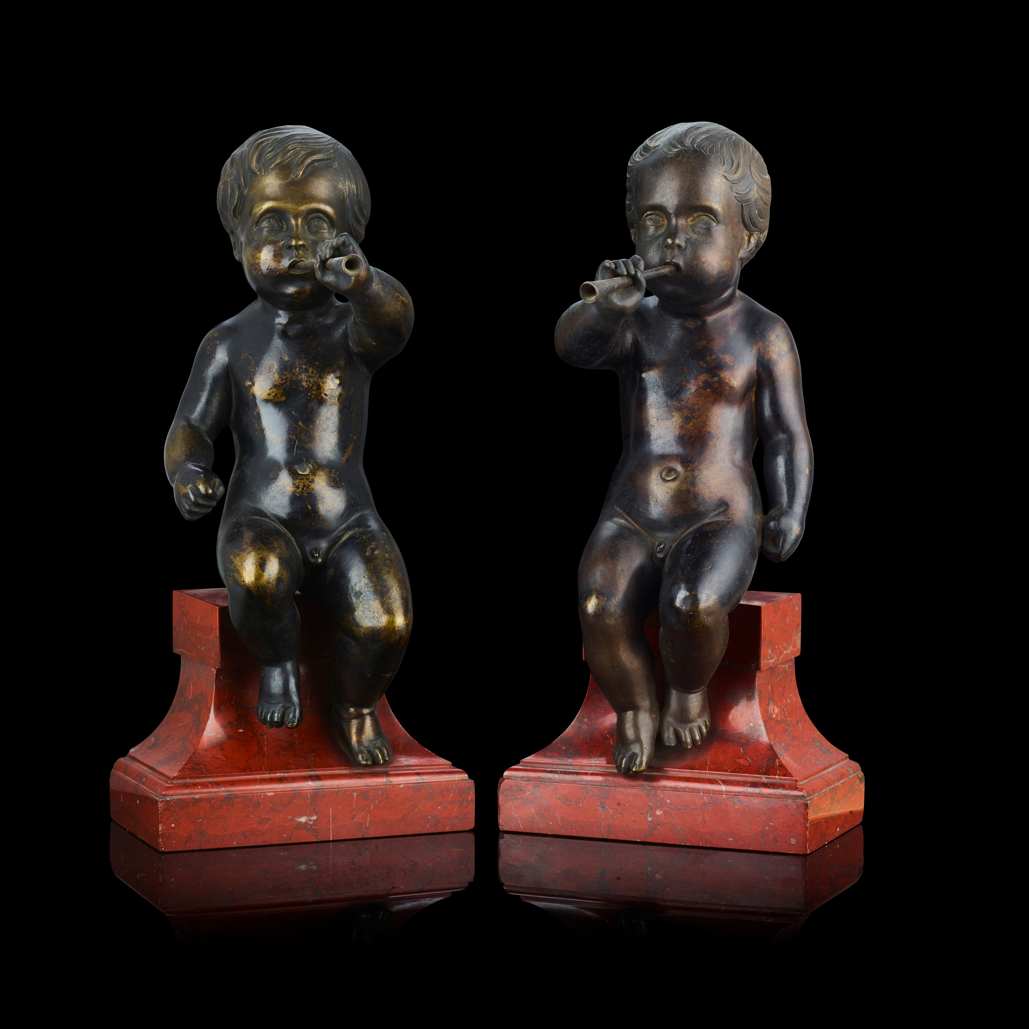 A PAIR OF NORTH EUROPEAN BRONZE FIGURES OF MUSICAL INFANTS
