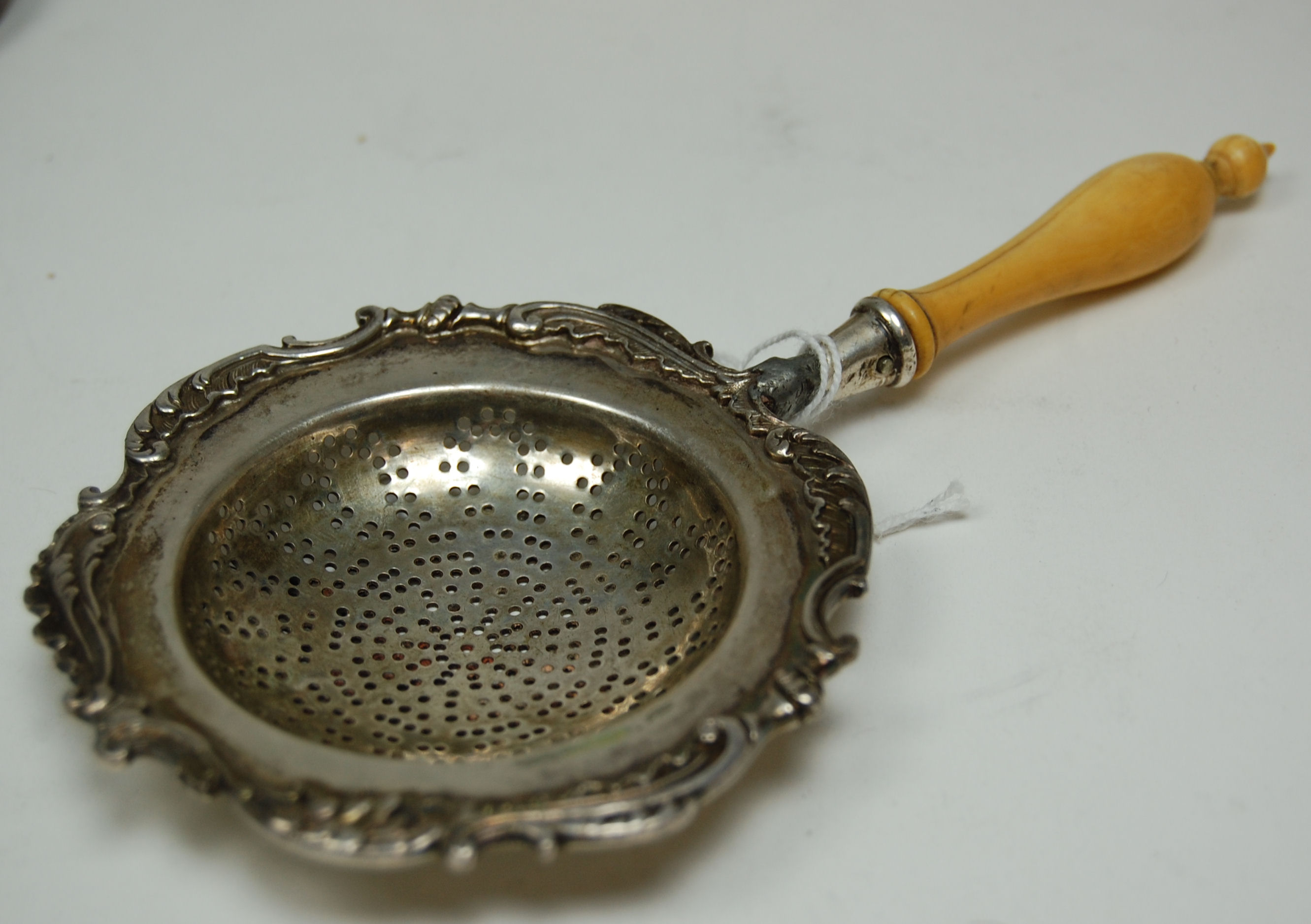 A Fabergé silver tea strainer