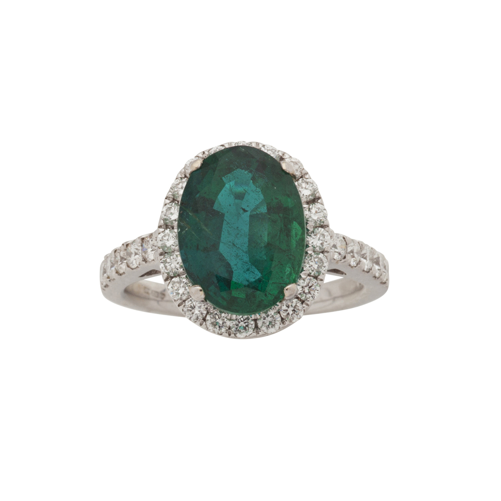 An emerald and diamond cluster ring