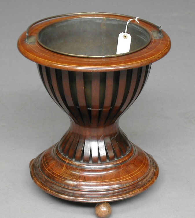 An Edwardian mahogany jardiniere