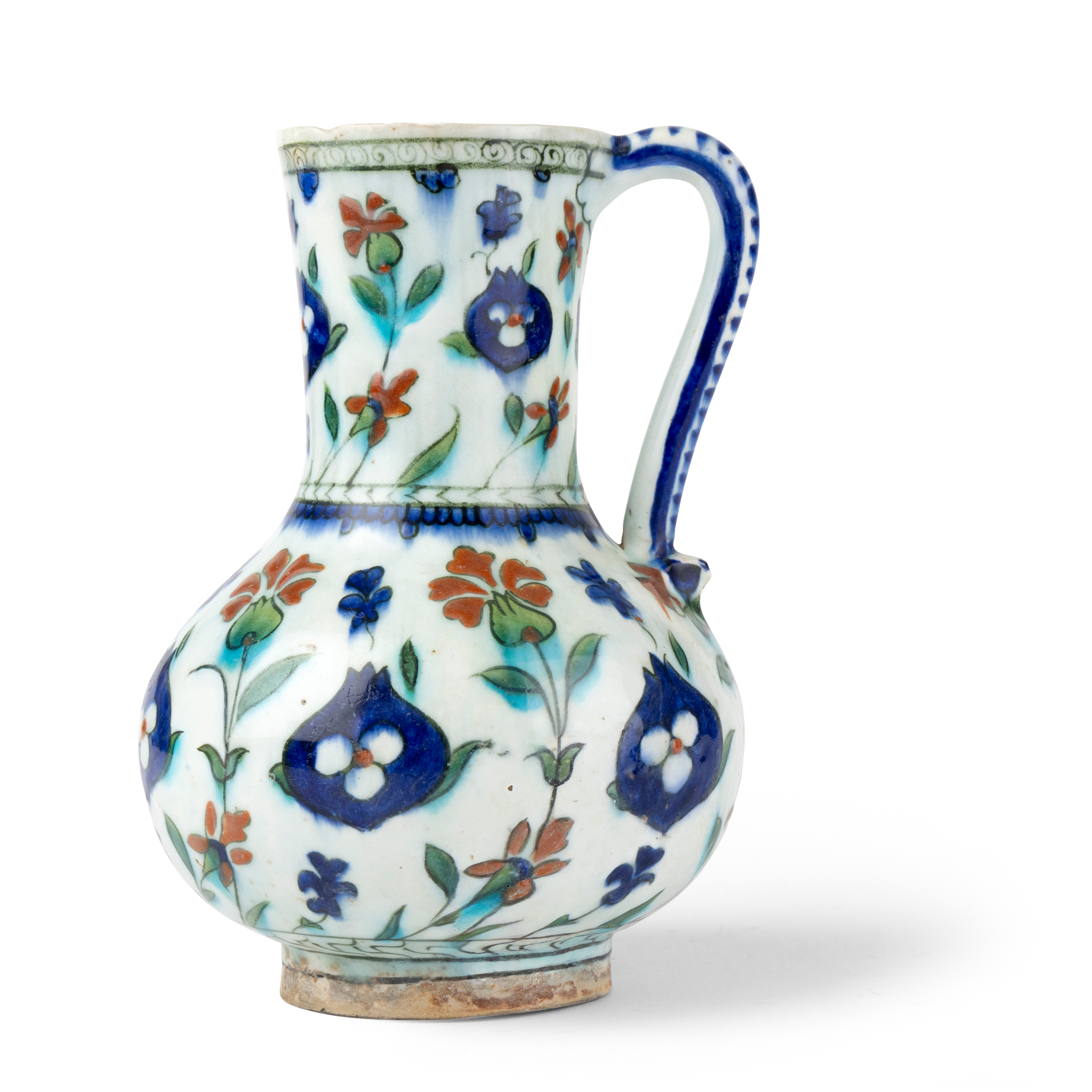 A STRIKING AND INTACT IZNIK POTTERY JUG DECORATED WITH CARNATIONS, POMEGRANATES & CINTEMANIS