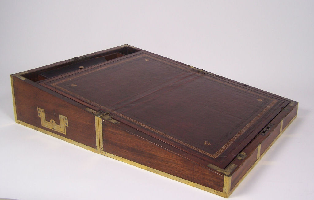 An early 19th century mahogany and brass bound lap desk
