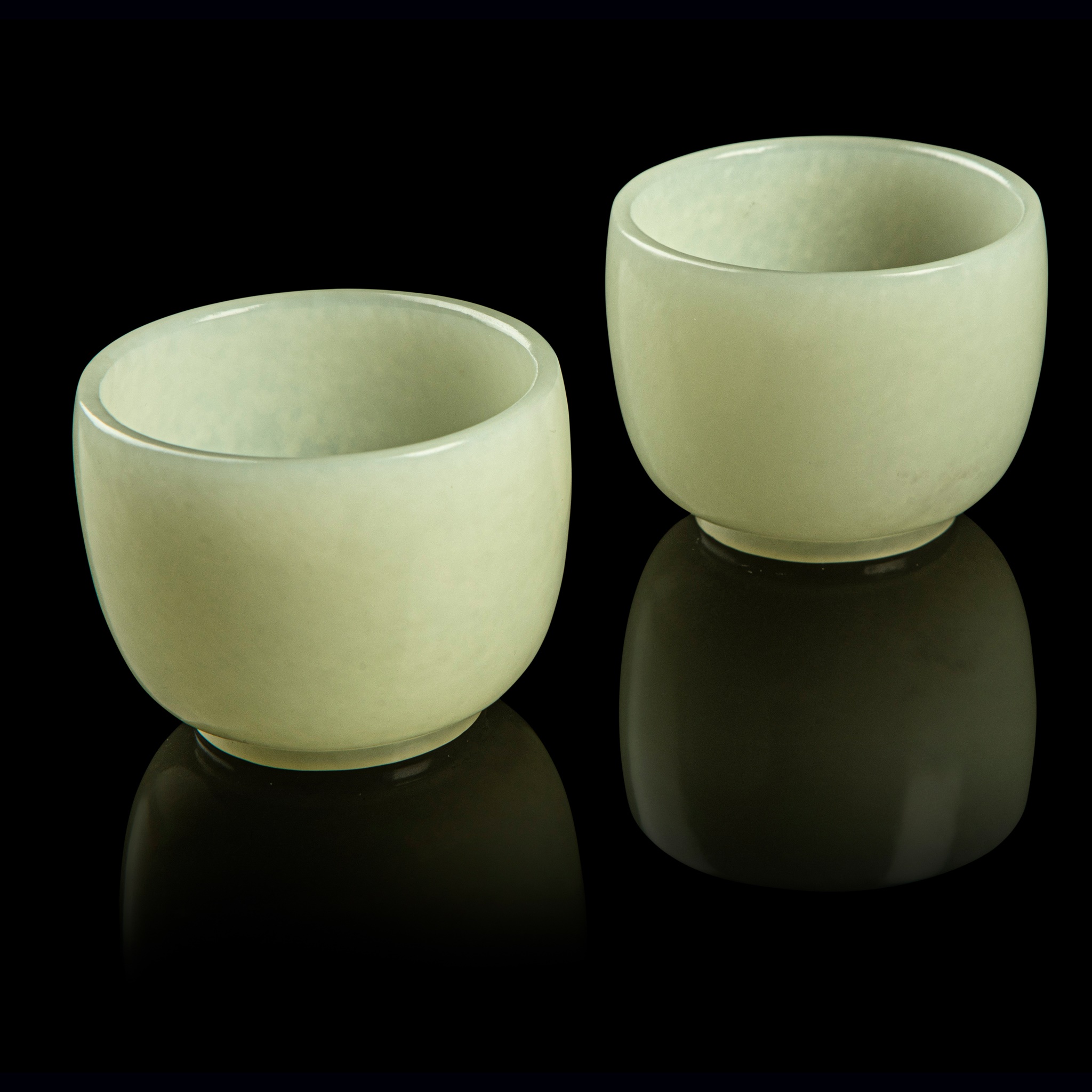 PAIR OF CELADON JADE CUPS