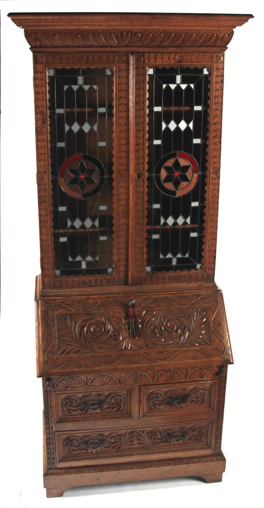 A carved oak bureau bookcase