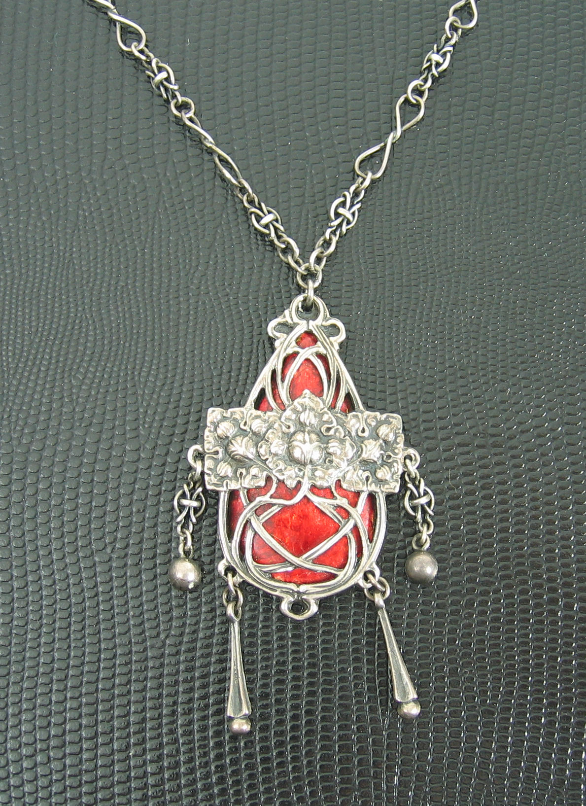 Ramsden & Carr - An Edwardian silver and enamel pendant,