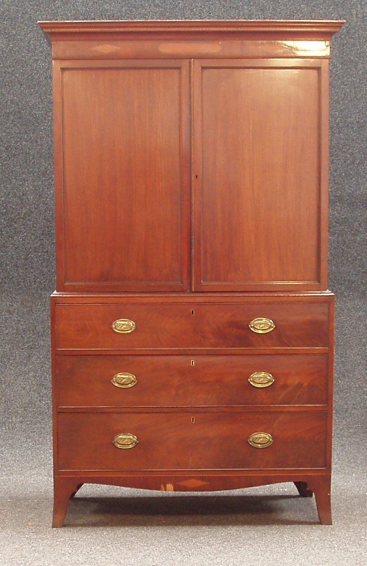 A small 19th century mahogany and inlaid linen press,