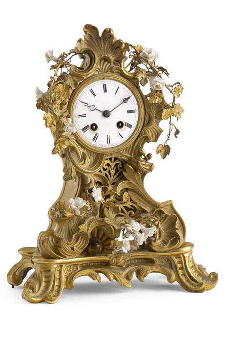 A 19th Century gilt bronze and porcelain mounted mantel clock In the Louis XV style