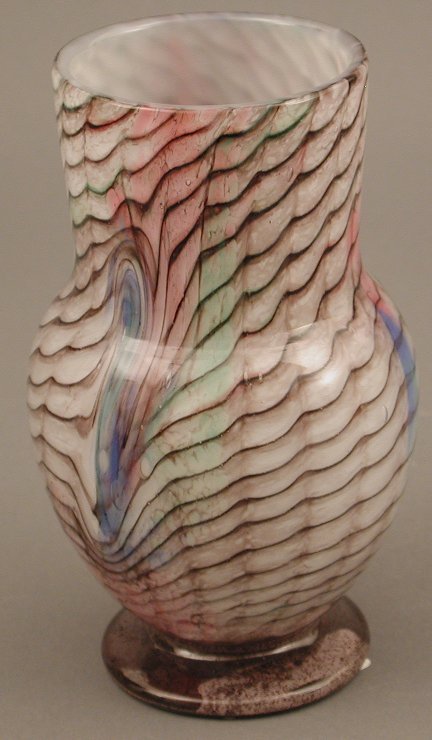 A cylindrical Monart glass vase