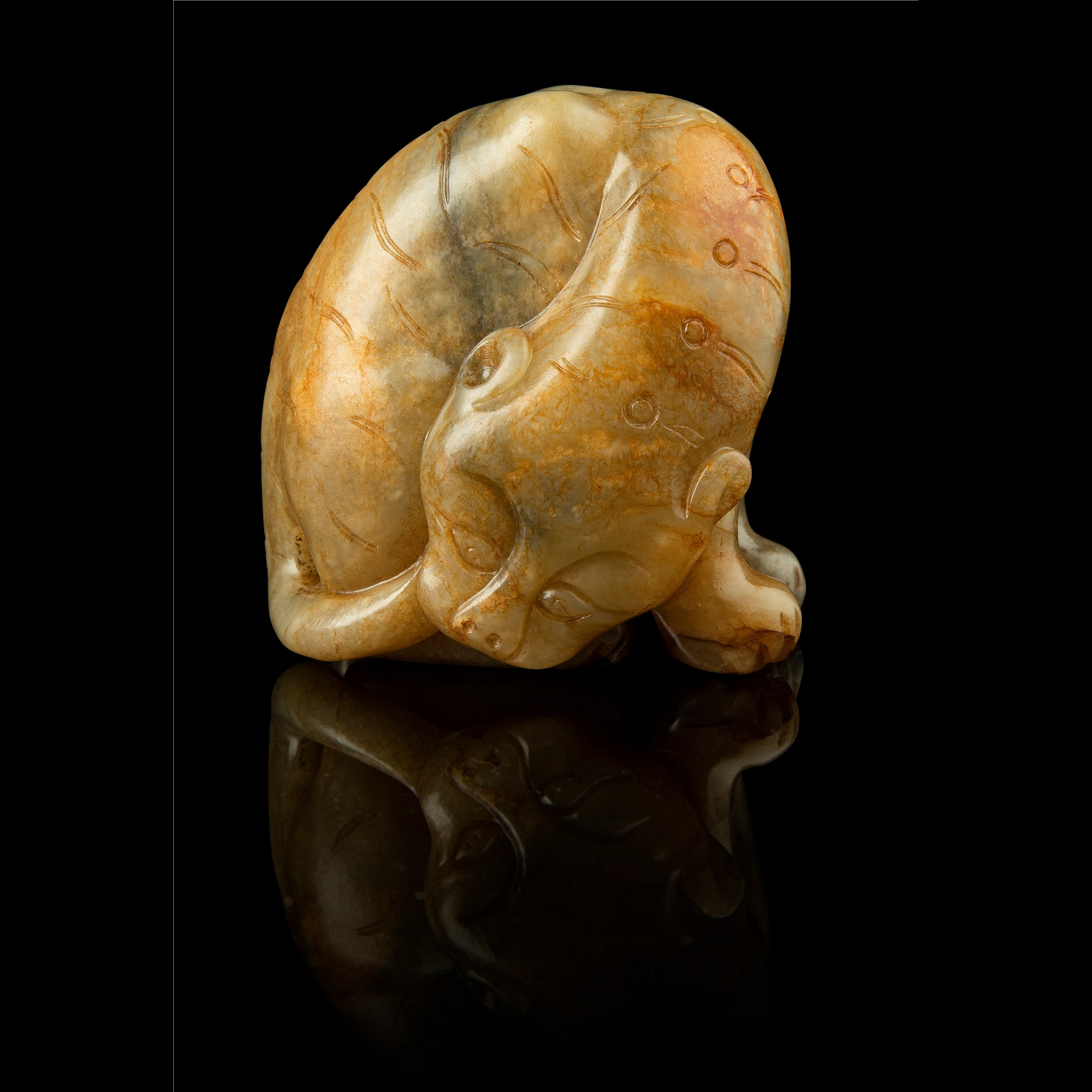 CELADON JADE WITH RUSSET SKIN CARVING OF A TIGER