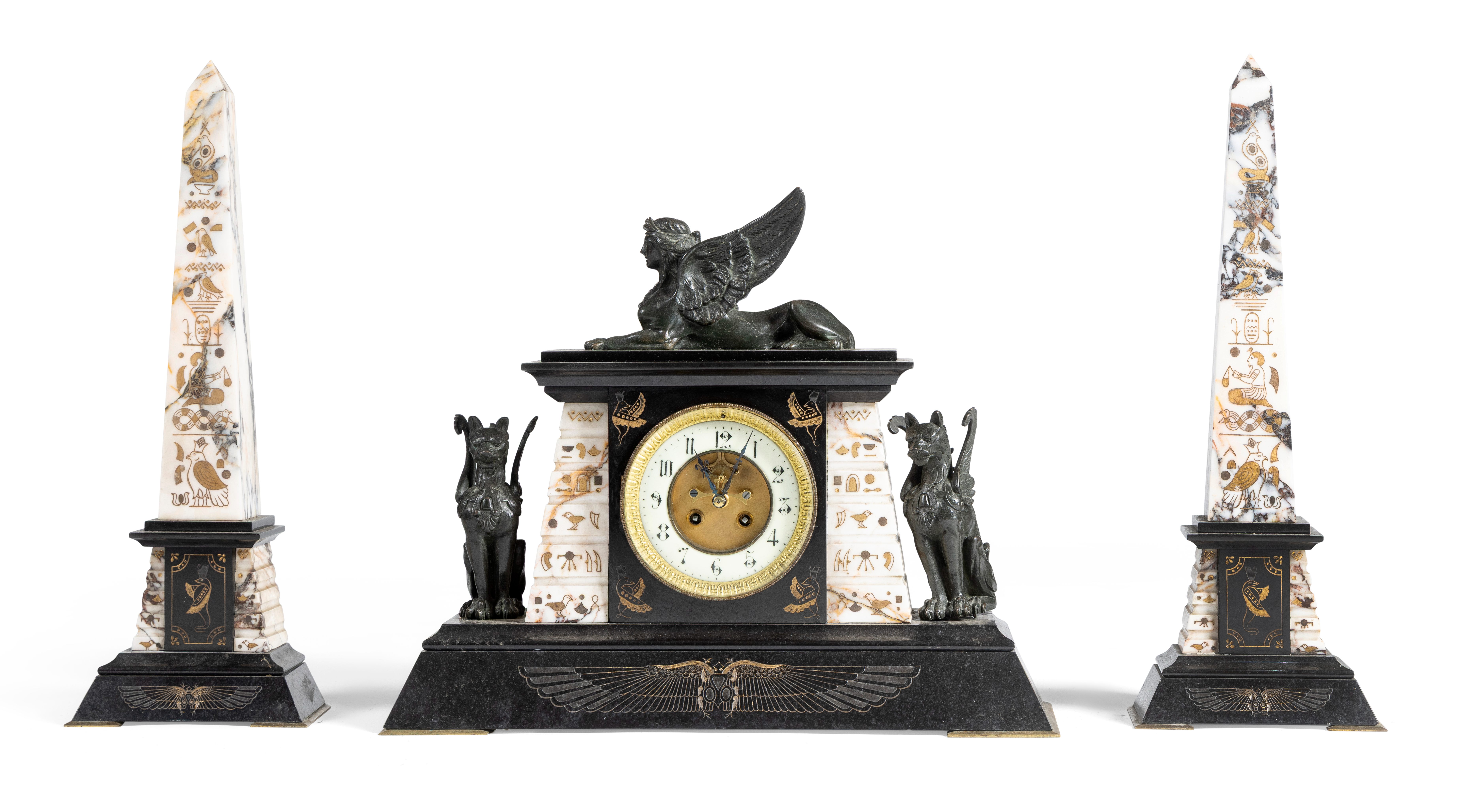 A BLACK SLATE AND MARBLE CLOCK GARNITURE OF EGYPTIAN TASTE