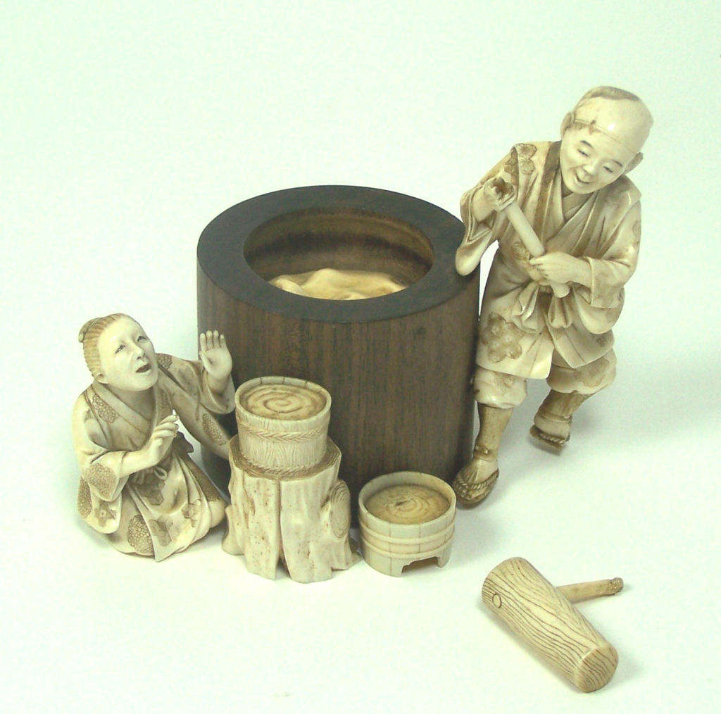 A Japanese ivory and wood okimono of laundry workers, Meiji period