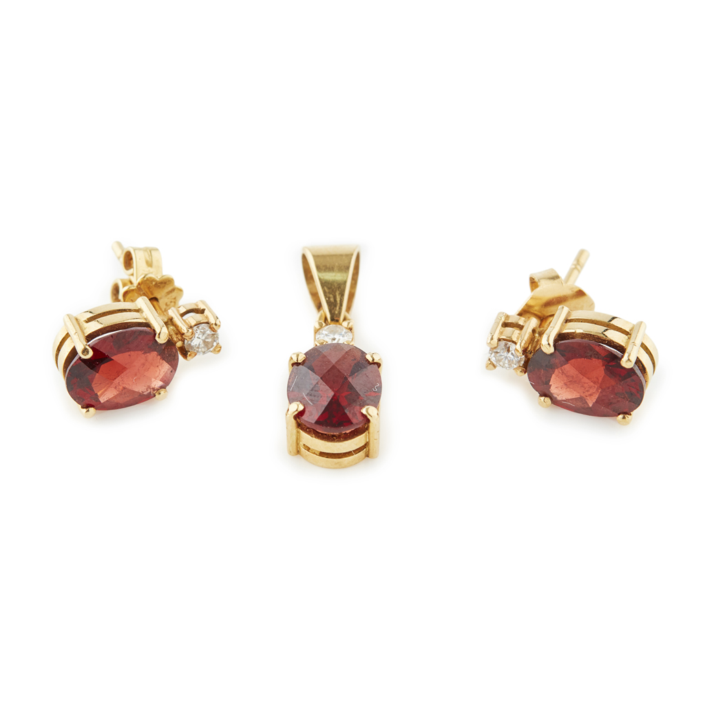 A garnet and diamond set pendant and matching earrings
