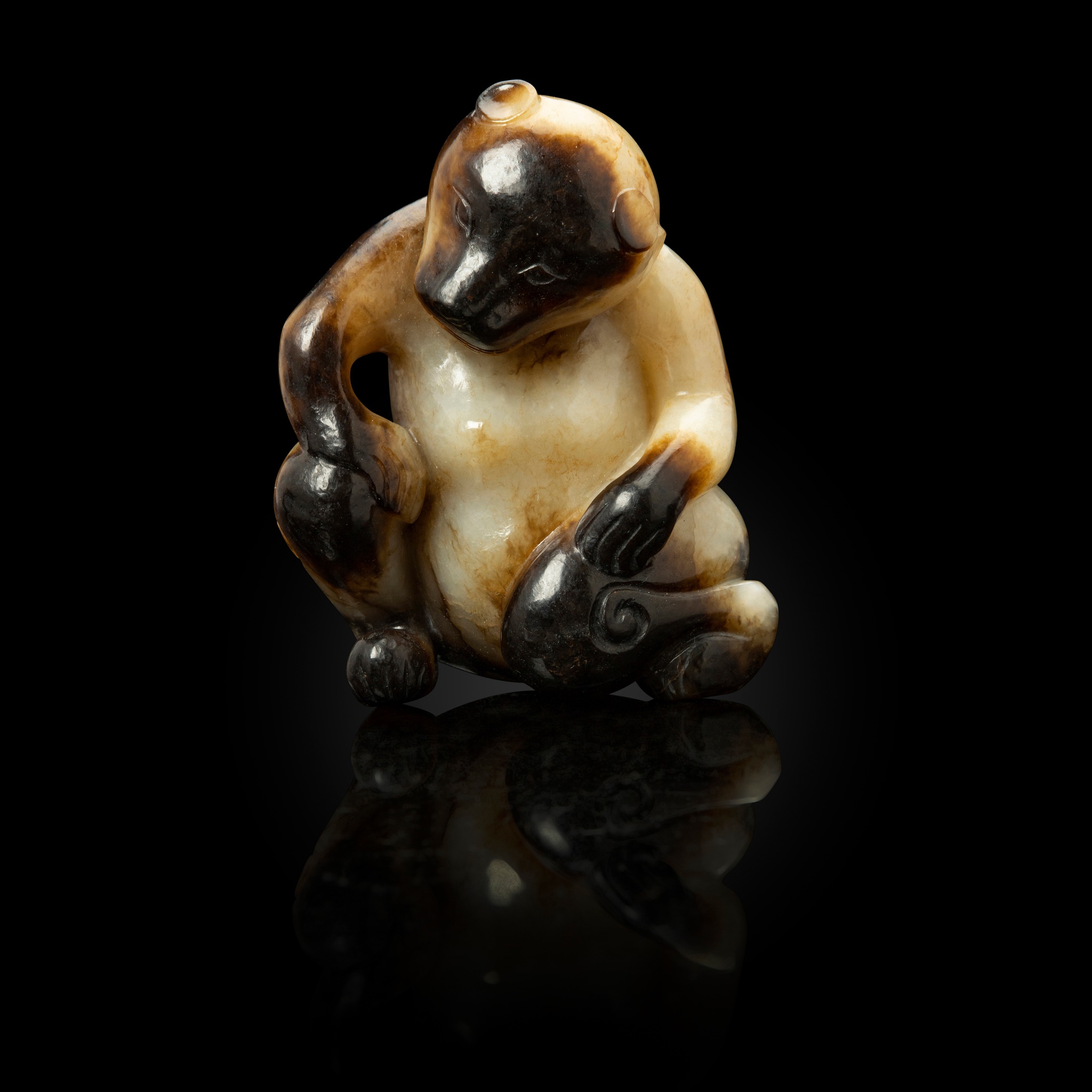 WHITE JADE WITH RUSSET SKIN CARVING OF A SEATED BEAR