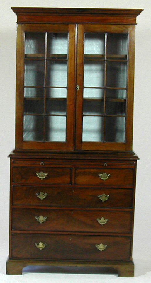 An early 19th century mahogany bookcase and associated chest,
