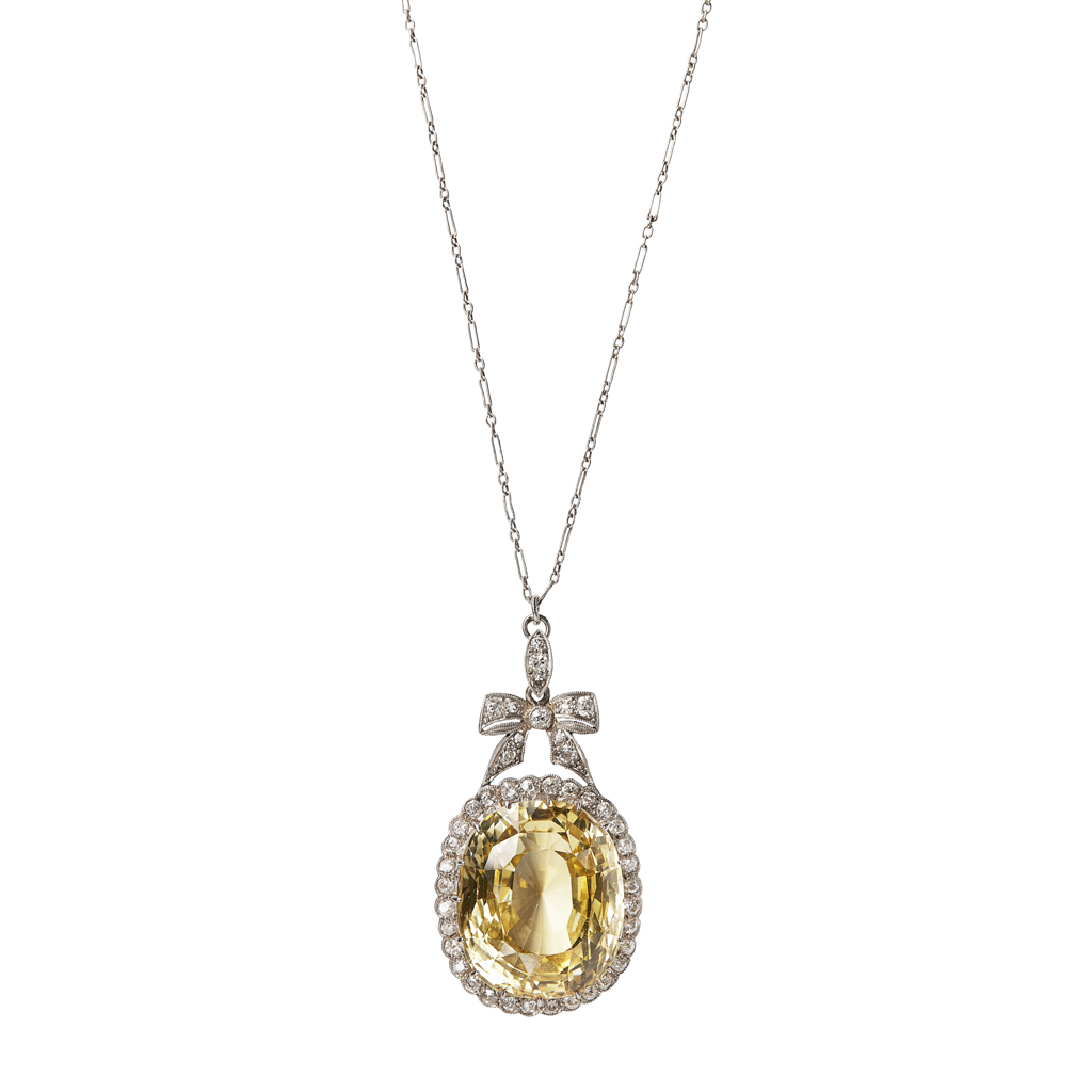 A yellow sapphire and diamond set cluster pendant