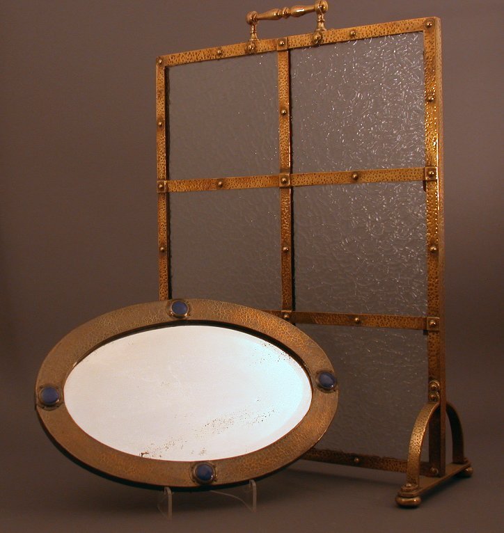 A brass framed firescreen